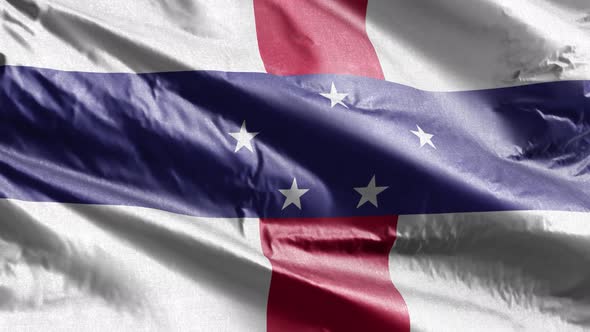 Netherlands Antilles textile flag waving on the wind. Slow motion. 20 seconds loop.  alt