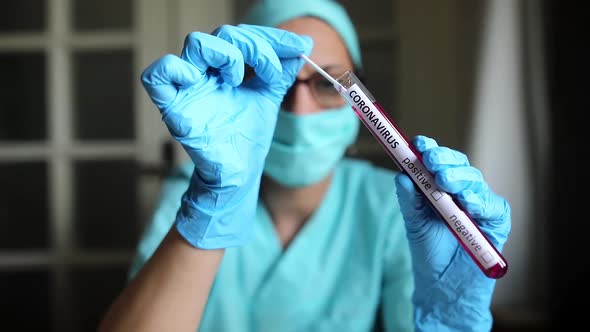 Doctor holding a coronavirus COVID-19 test tube