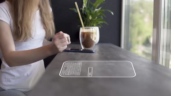 Video where a girl is typing a message on the phone while in a cafe while drinking a cocktail alt