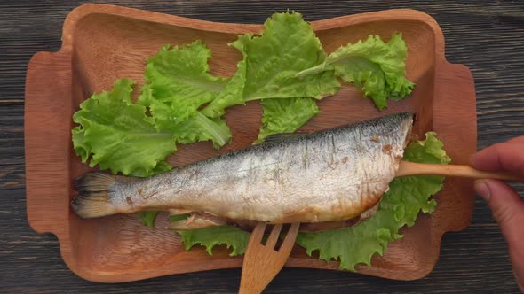 Top View of the Juicy Grilled Red Char Fish Opened with Wooden Fork and Spatula alt