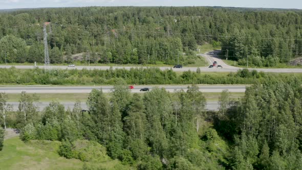 Fast aerial shot following cars driving quickly on a Finnish motorway near Kerava. alt