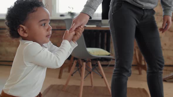 Fussy Toddler Boy Holding Mothers Hand alt