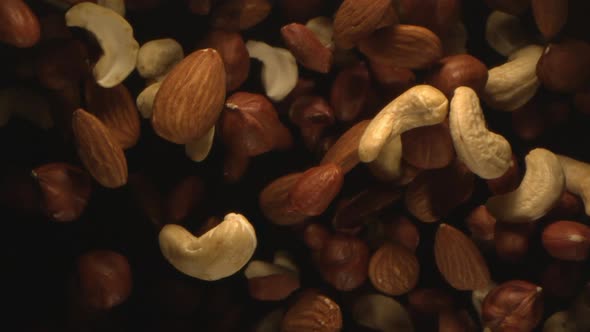 Nuts Are Tossed In The Air In Slow Motion alt