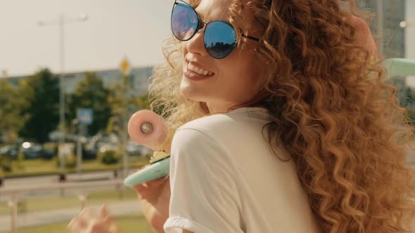 Young beautiful sexy smiling hipster woman with afro curls hairstyle posing outdoors alt