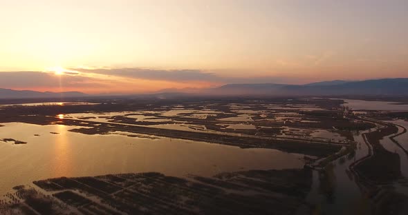 Aerial, Beautiful Fall Landscape On A Big Pond  On Sunset With Low Water And Sun Reflections 