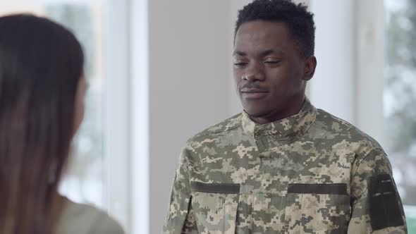 Happy Young African American Man Hugging Caucasian Brunette Woman Looking at Camera Smiling alt