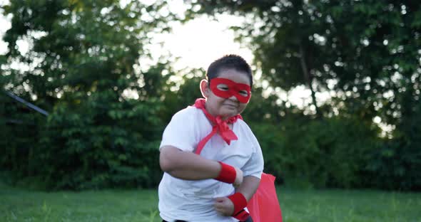 Fat super hero kid dancing in garden alt