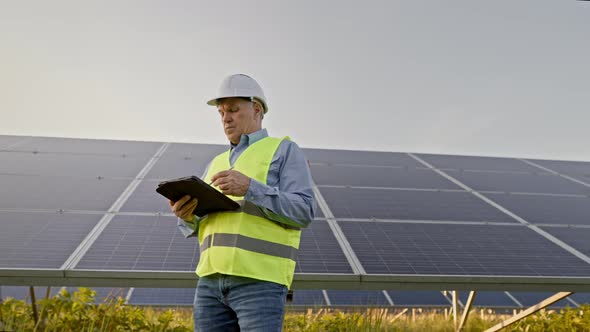 Engineer Man Working at Alternative Energy Farm alt