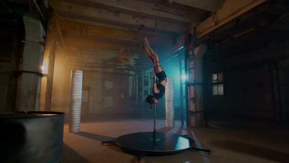 A Cyberpunk Style Girl Descends With A Pole Through A Twine And Sits On The Floor.  alt