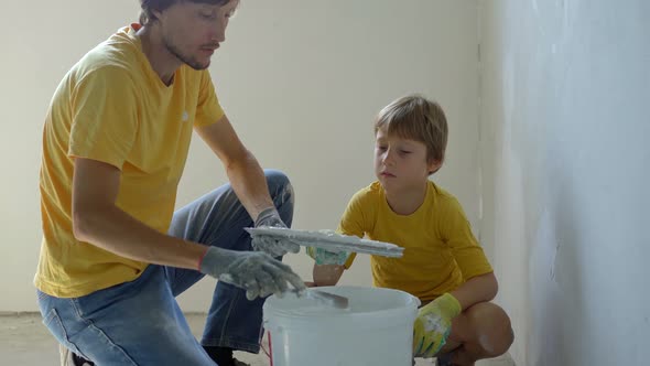 A Young Man and His Son are Doing a Walls Renovation in Their Home alt