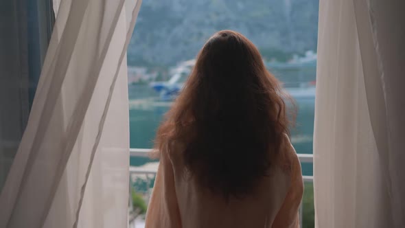 Asian Young Woman Opening Curtain Lace Standing in Luxury Apartment Home Hotel Looking Through alt