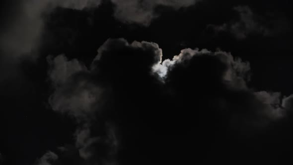 Full Moon Moving Between Clouds alt