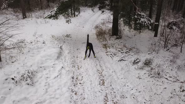 Man Doing Warm Up Exercises In A Winter Forest