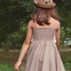 Back view of little girl in a straw hat and dress walking in the park - VideoHive Item for Sale