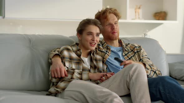 Happy Girlfriend Watching Tv with Ginger Man on Weekend alt