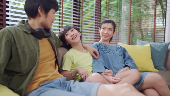 Asian family sit relax positive conversation with son, happiness smile boy casual talking