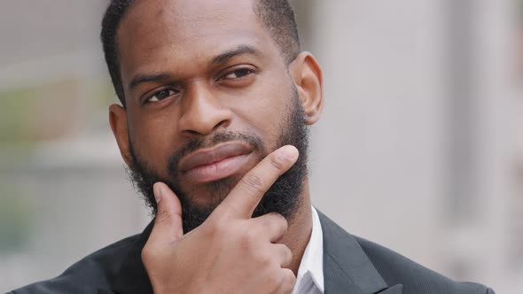 Thoughtful Serious African American Businessman Boss or Intern Wearing Suit Outdoors Thinking of alt
