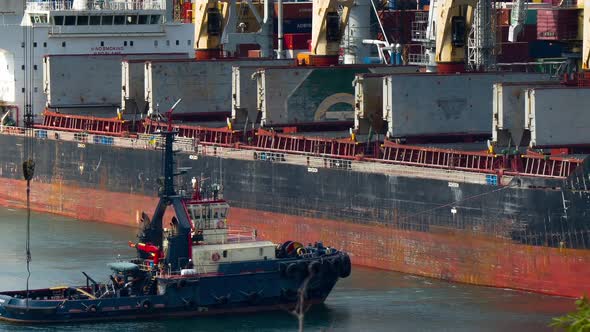 Tugboats Assisting Container Cargo Ship alt