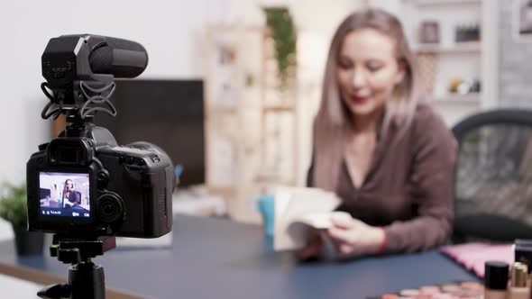 Vlogger Making a Book Review in Fron of the Camera in Her Creative Studio alt