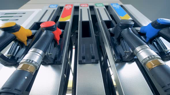 Male Hand Is Putting a Green Gas Pistol Back Into Its Pump alt