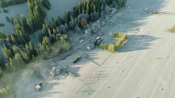 Poland countryside with several farmstead next to grassland at dawn, aerial alt