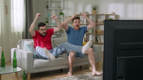 Day at Home Two Soccer Fans Sitting on a Couch Watch Game on TV Dance for Celebrate Victory When alt