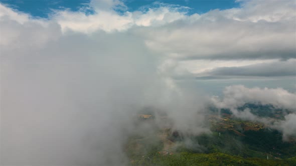 Aerial time lapse of fog over hills after rain