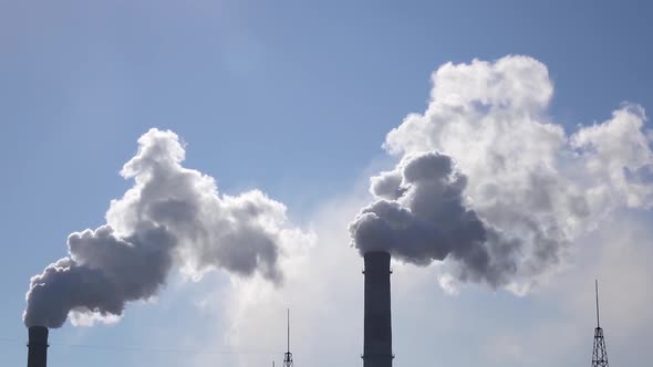 Air Pollution From Industrial Chimneys Spew Clouds Smoke in Sky alt