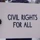 A Male Activist stands in a park protest with a Civil Rights for All poster - VideoHive Item for Sale
