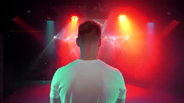 DJ in the club goes on the dance floor alt