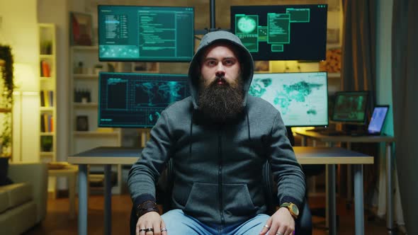 Bearded Hacker Wearing a Hoodie Using Augmented Technology alt