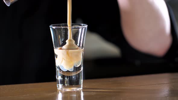 Barman is Making Alcohol Cocktail with Three Layers