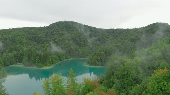Aerial view of forest with fog and lake in Plitvice National Park, Croatia 4K