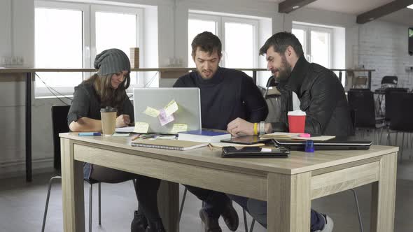 Team of Young Professionals Having a Meeting in a Creative Office alt