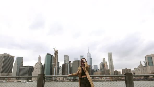 Attractive Woman Resting Near The Brooklyn Bridge. alt