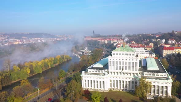A huge spring evaporation of Vltava river in haze,Prague city,Czechia,aerial view. alt