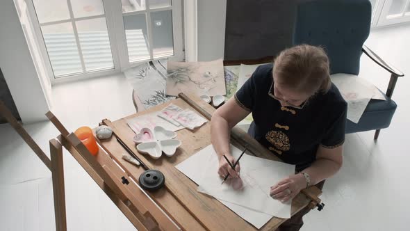 Authentic Senior Woman Artist Painting Indoors alt