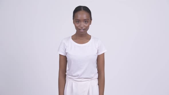 Happy Young Beautiful African Woman Giving Thumbs Up and Looking Excited alt