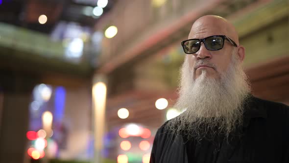 Mature Bald Bearded Tourist Man Waiting Against View of the City at Night