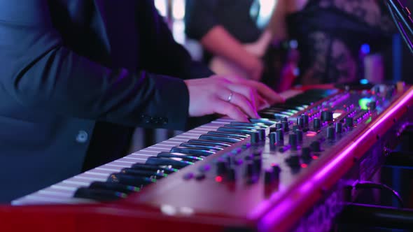 A Caucasian Man Plays Electric Piano at a Concert Party Music Party Neon Colors Playing Chords on alt
