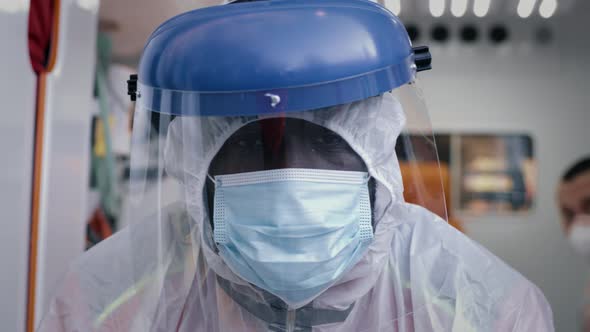 African American Paramedic in Hazmat Suit Looking at Camera alt