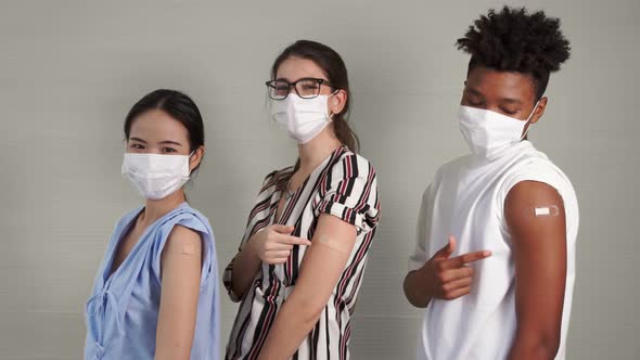 Diverse Group of People Showing COVID19 Vaccine Bandage Merrily alt