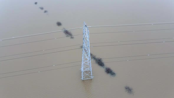 An Electricity Pylon in Deep Water in a Floodwaters Causing Power Cuts alt