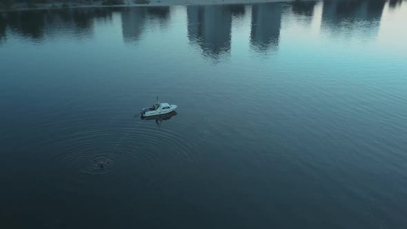 Motorboat Picks Up a Surfer Who Has Fallen Into the Water Evening Light