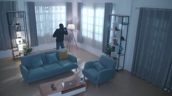 Cctv View Of Thief Man Holding Flashlight Walking In Someone's House alt