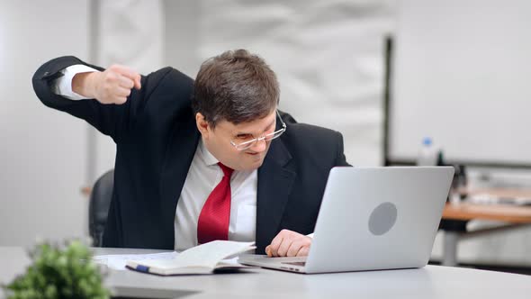 Angry Male Boss Pounding Table in Fury Looking at Screen of Laptop Medium Shot on RED Camera alt