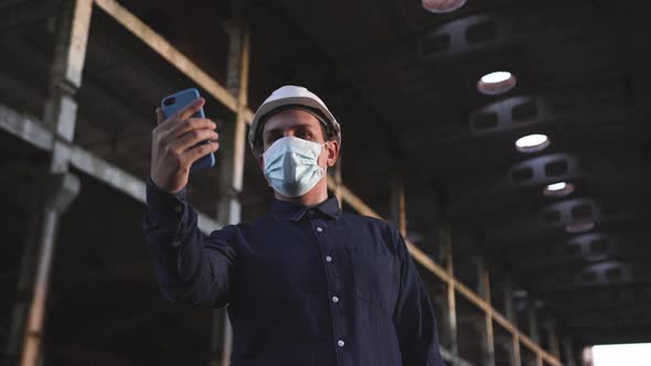 Engineer at the Facility Is Talking Over Video Communication on the Phone alt