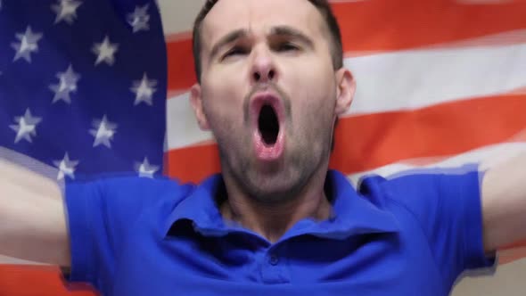 American Fan Celebrates Holding the Flag of USA alt