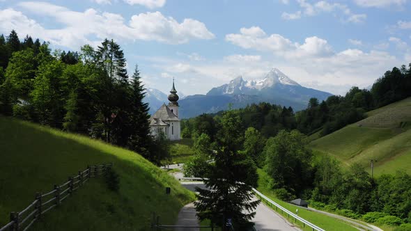 Aerial Fly Towards Church Maria Gern Mount Watzmann in Background Berchtesgaden Bavaria Germany alt