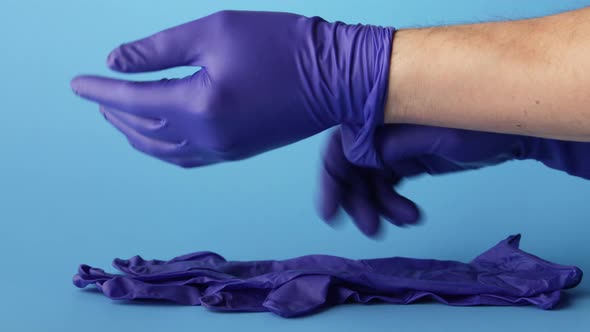 Doctor putting on medical latex gloves 